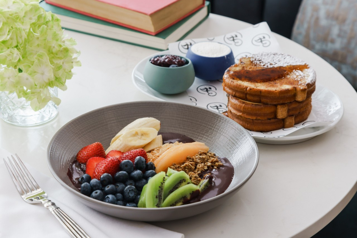 a bowl of fruit and a stack of french toast