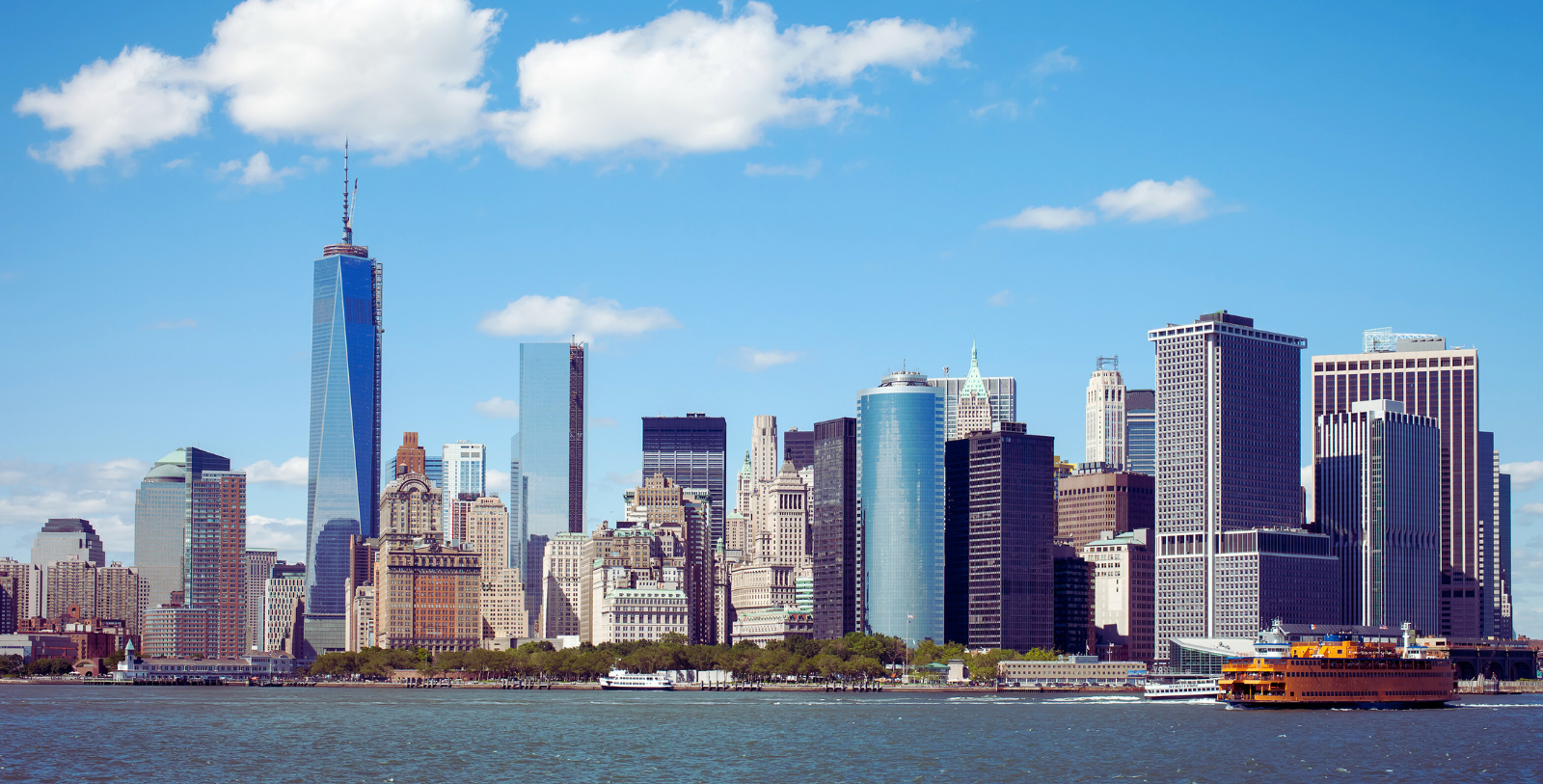a city skyline with tall buildings and a body of water