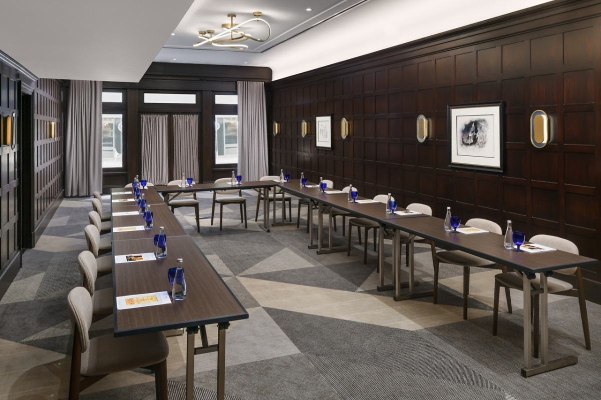 a room with long tables and chairs