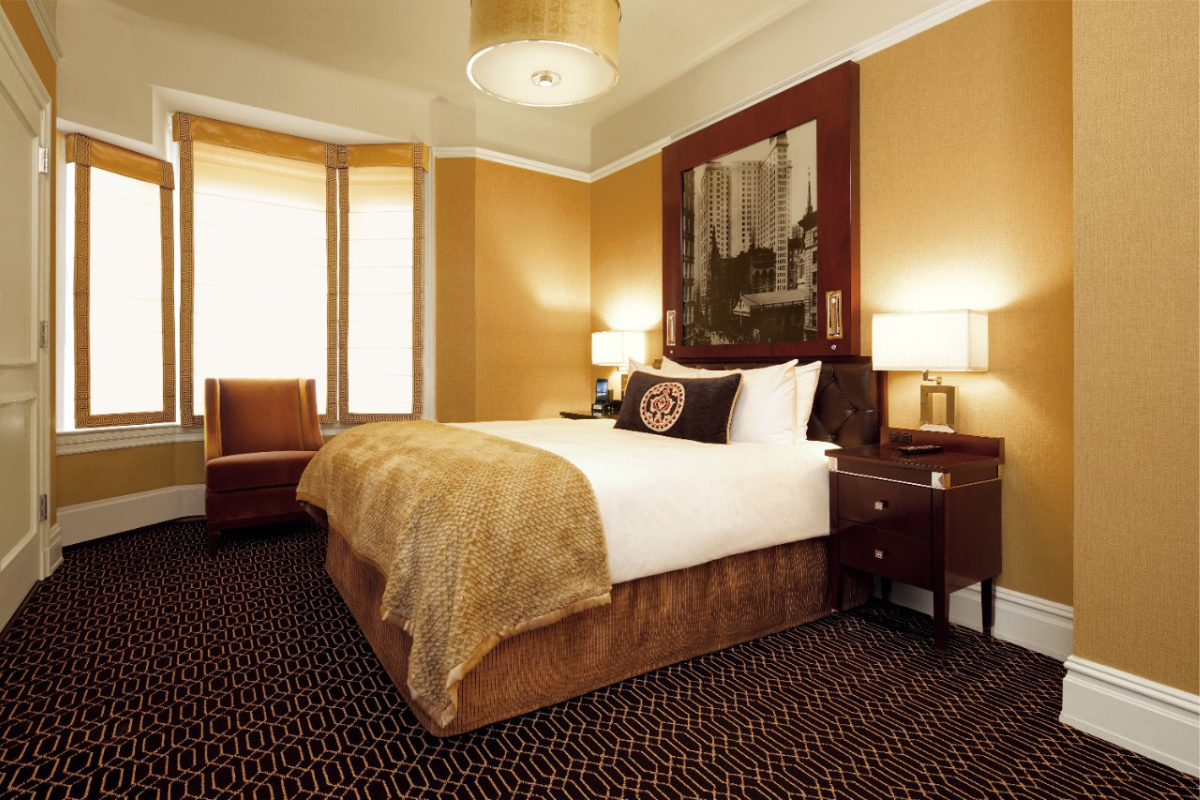 a bedroom with a bed and a picture on the wall