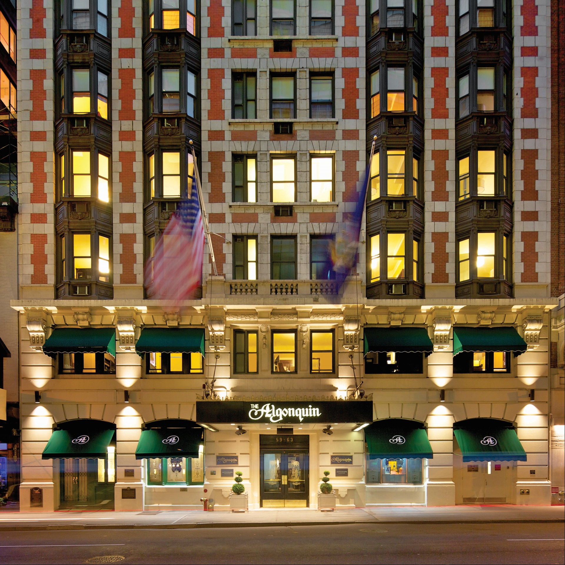 a building with many windows and flags
