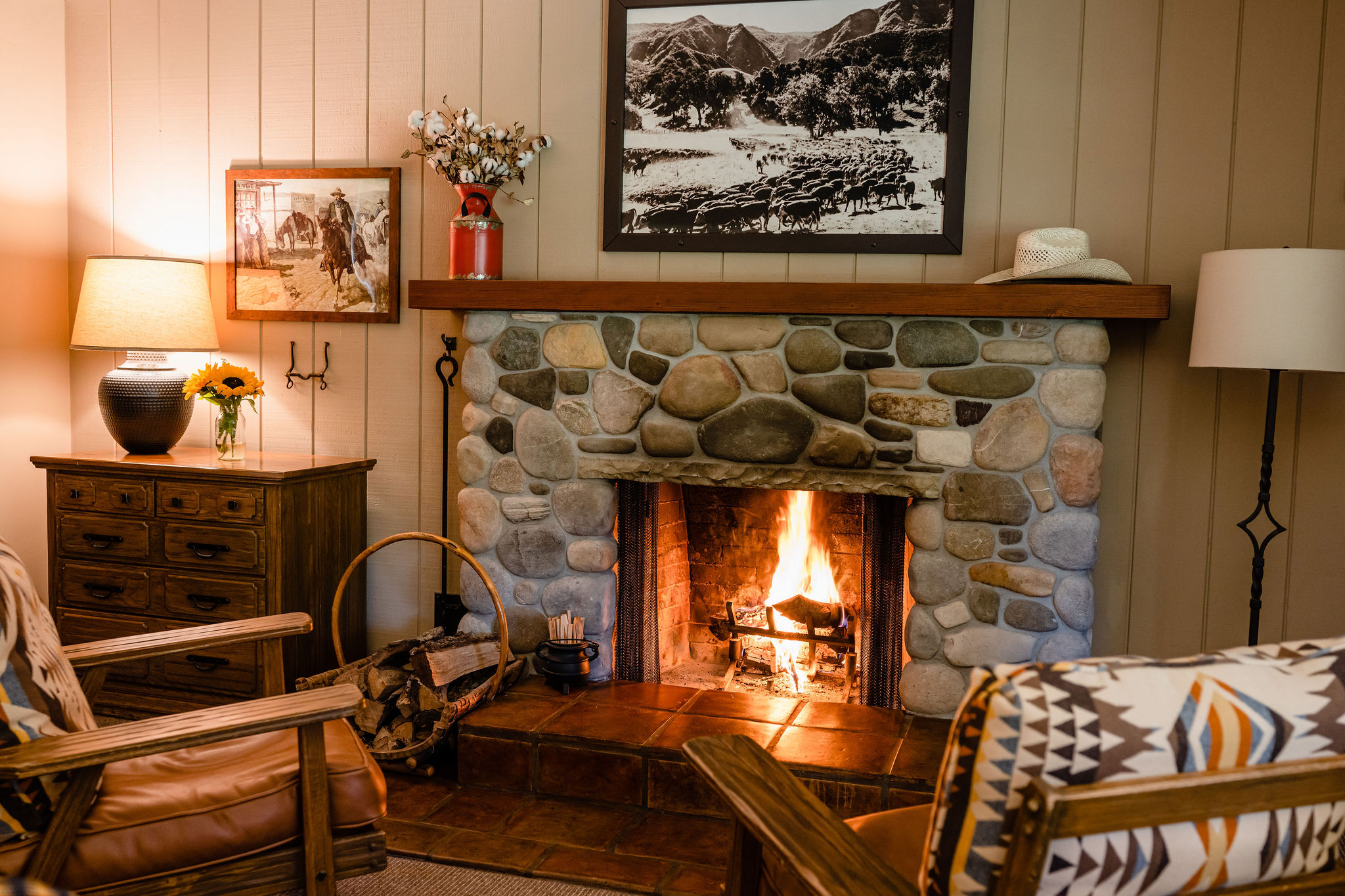 a fireplace with a wood shelf and a picture on the wall