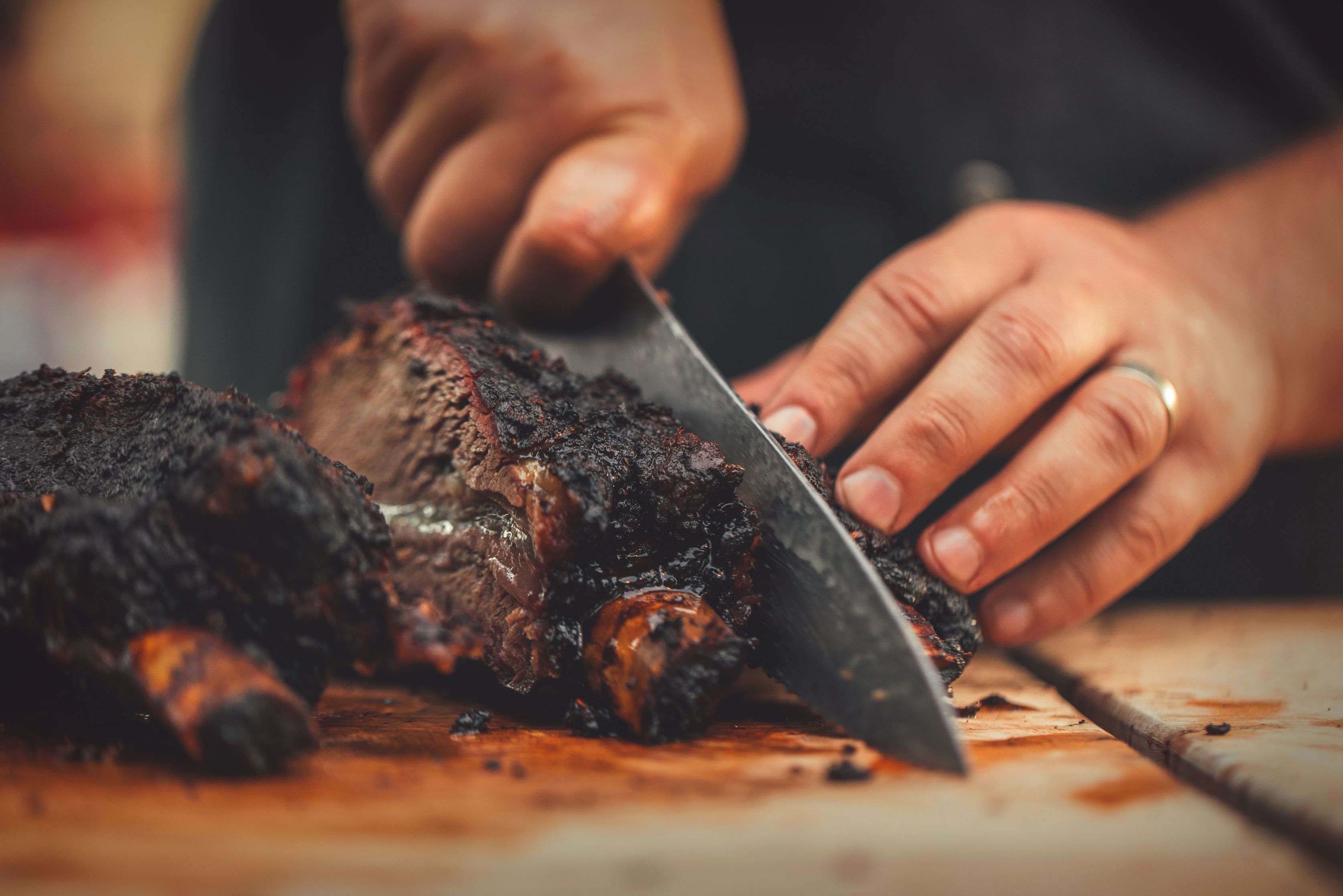 a person cutting meat with a knife