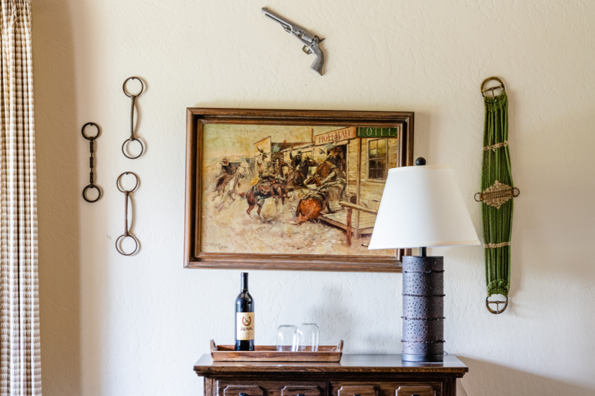 a picture of a cowboy on a table with a lamp and a gun