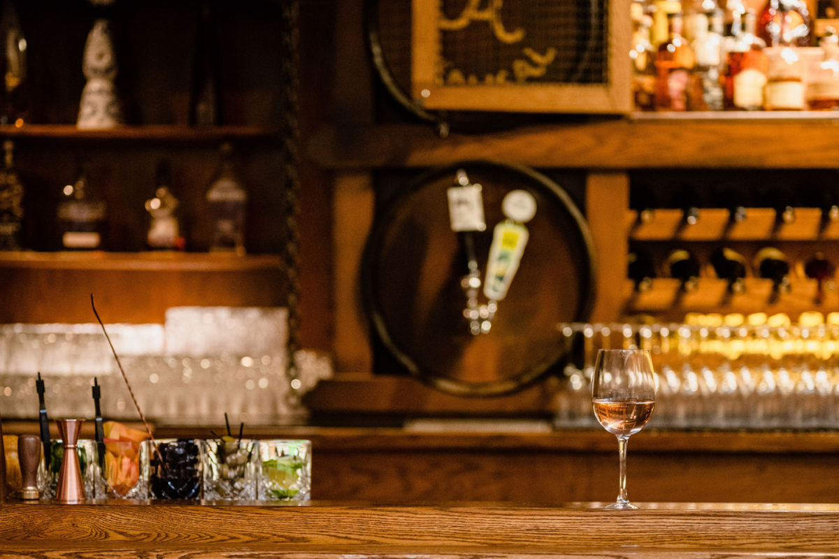 a glass of wine on a bar