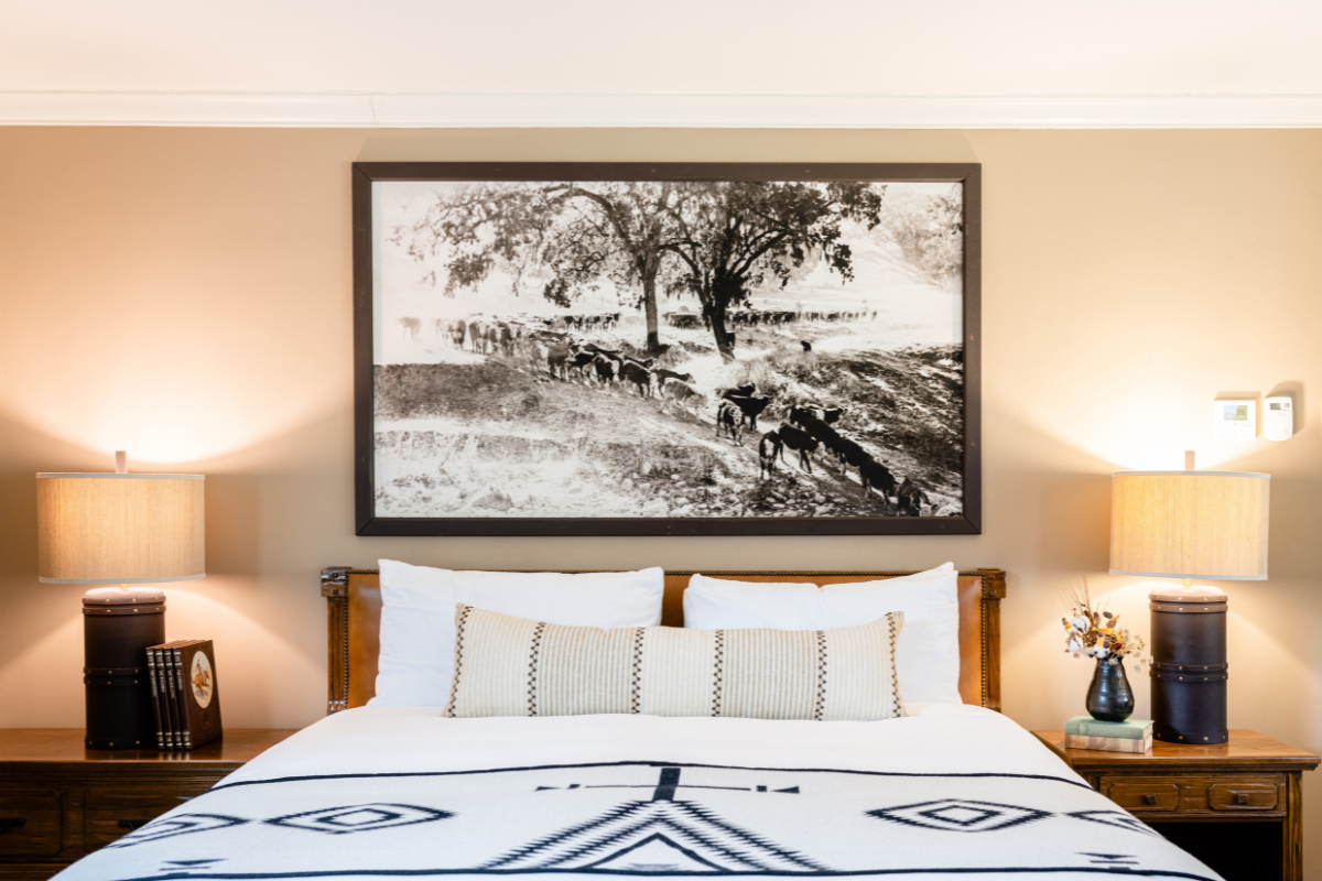 a bed with a picture above it