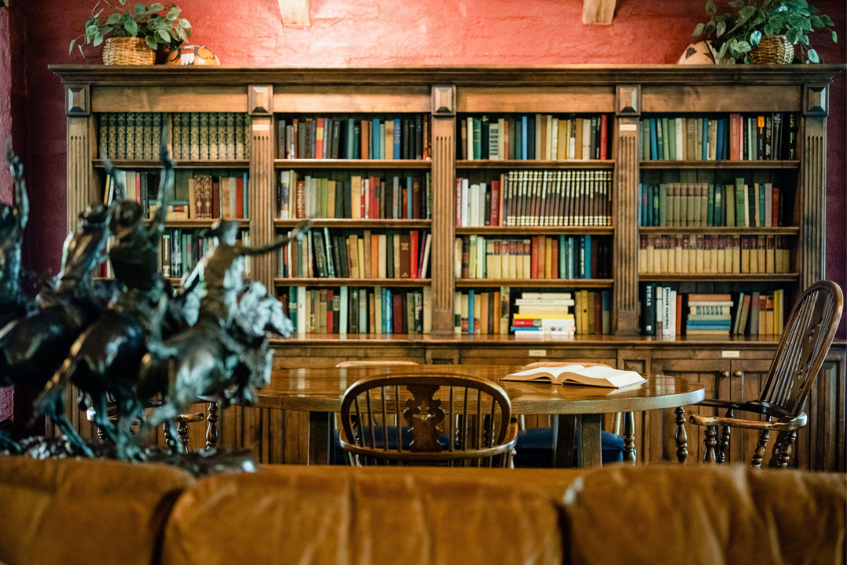 a room with a bookcase and a table