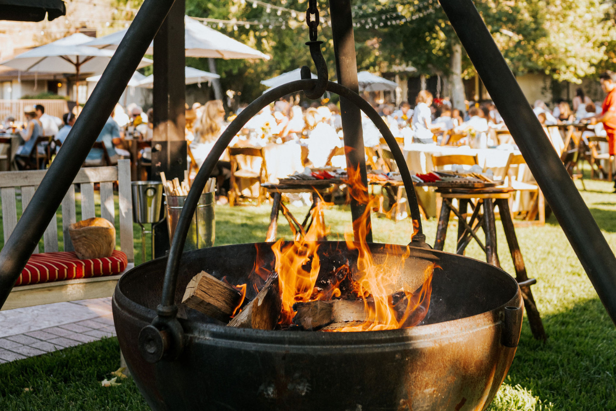a fire pit with people around it