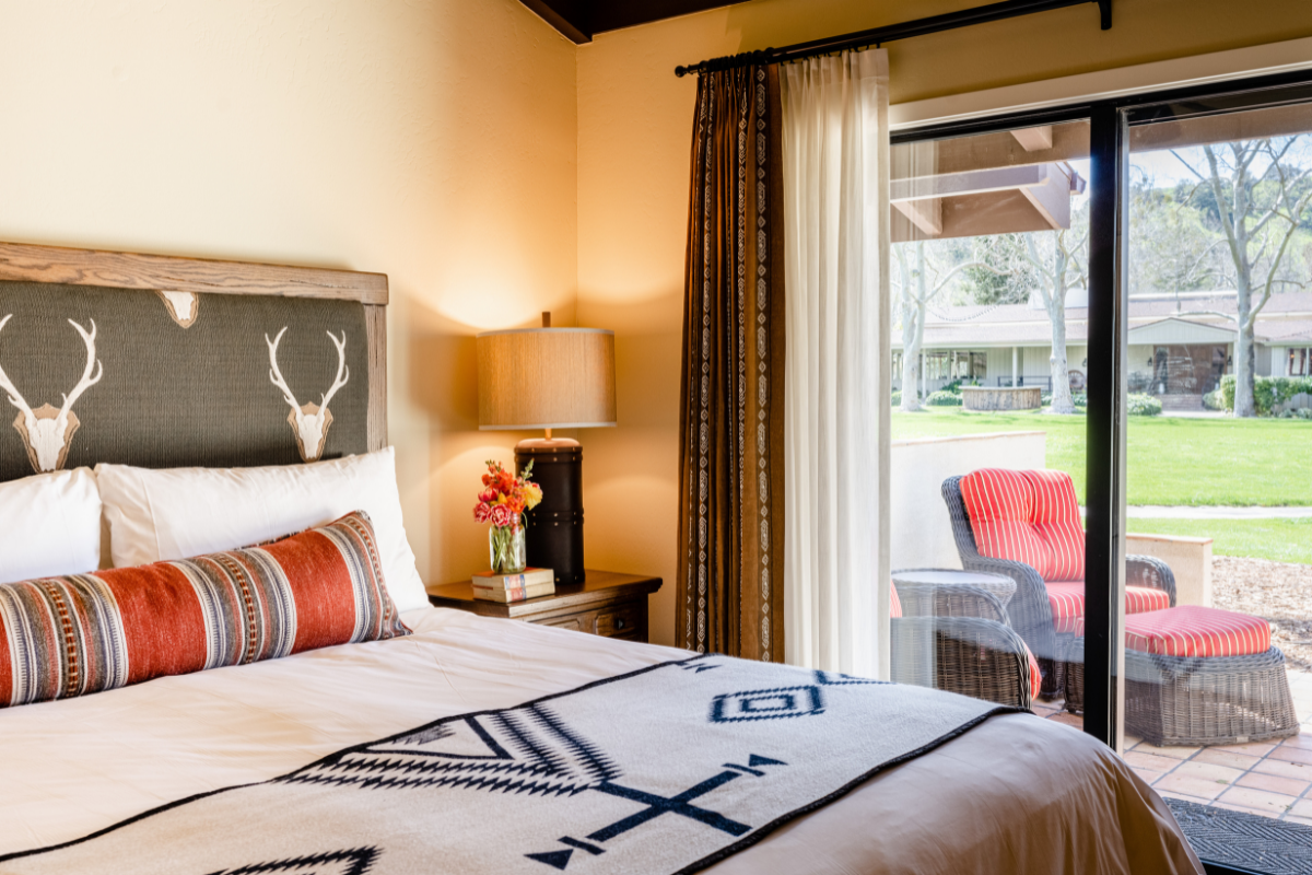 a bed with a lamp and a table next to it
