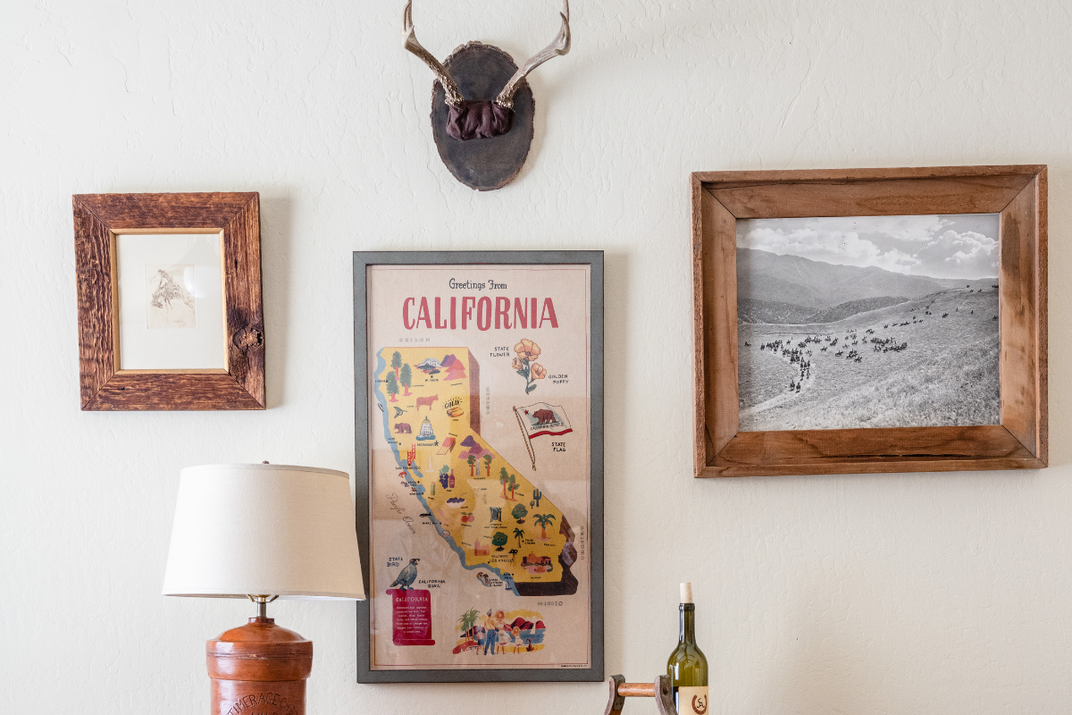 a picture frame and a bottle of wine on a wall