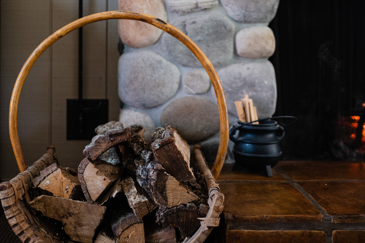 a basket of wood next to a stack of wood