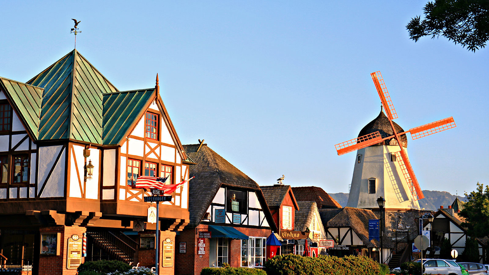 a row of buildings with a windmill in the background