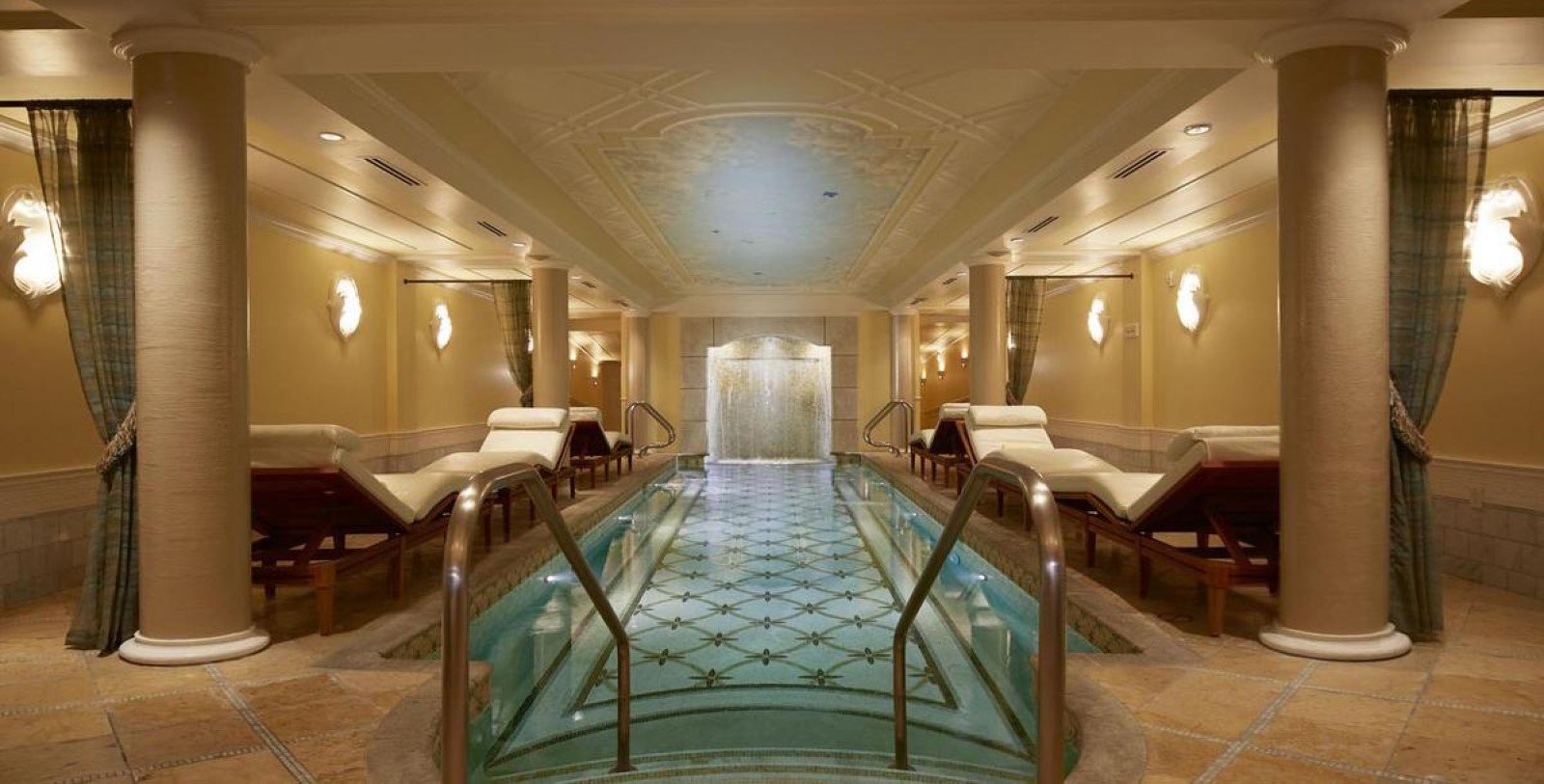 a pool with chairs in a room