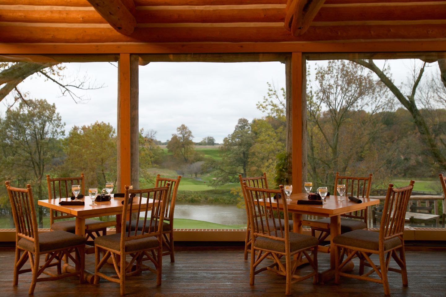 a room with a view of a golf course and trees