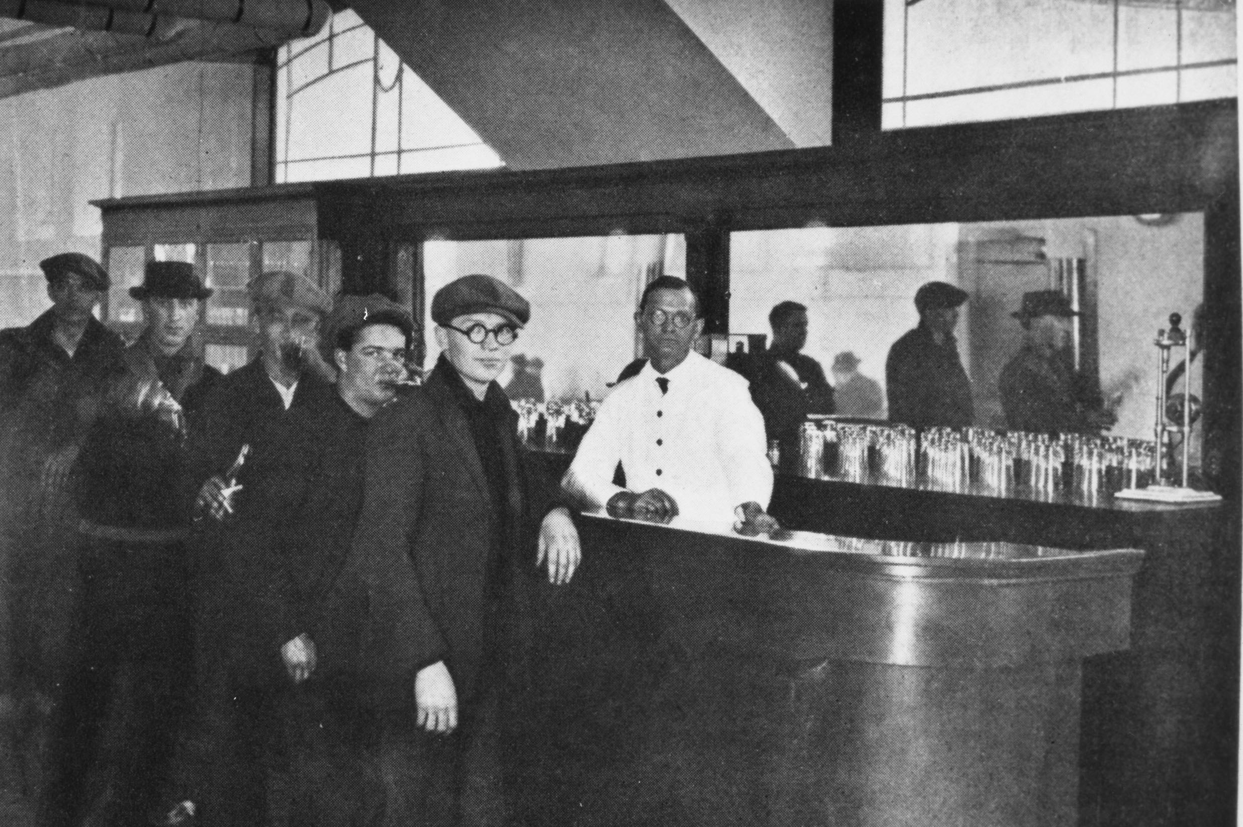 a group of men standing behind a counter