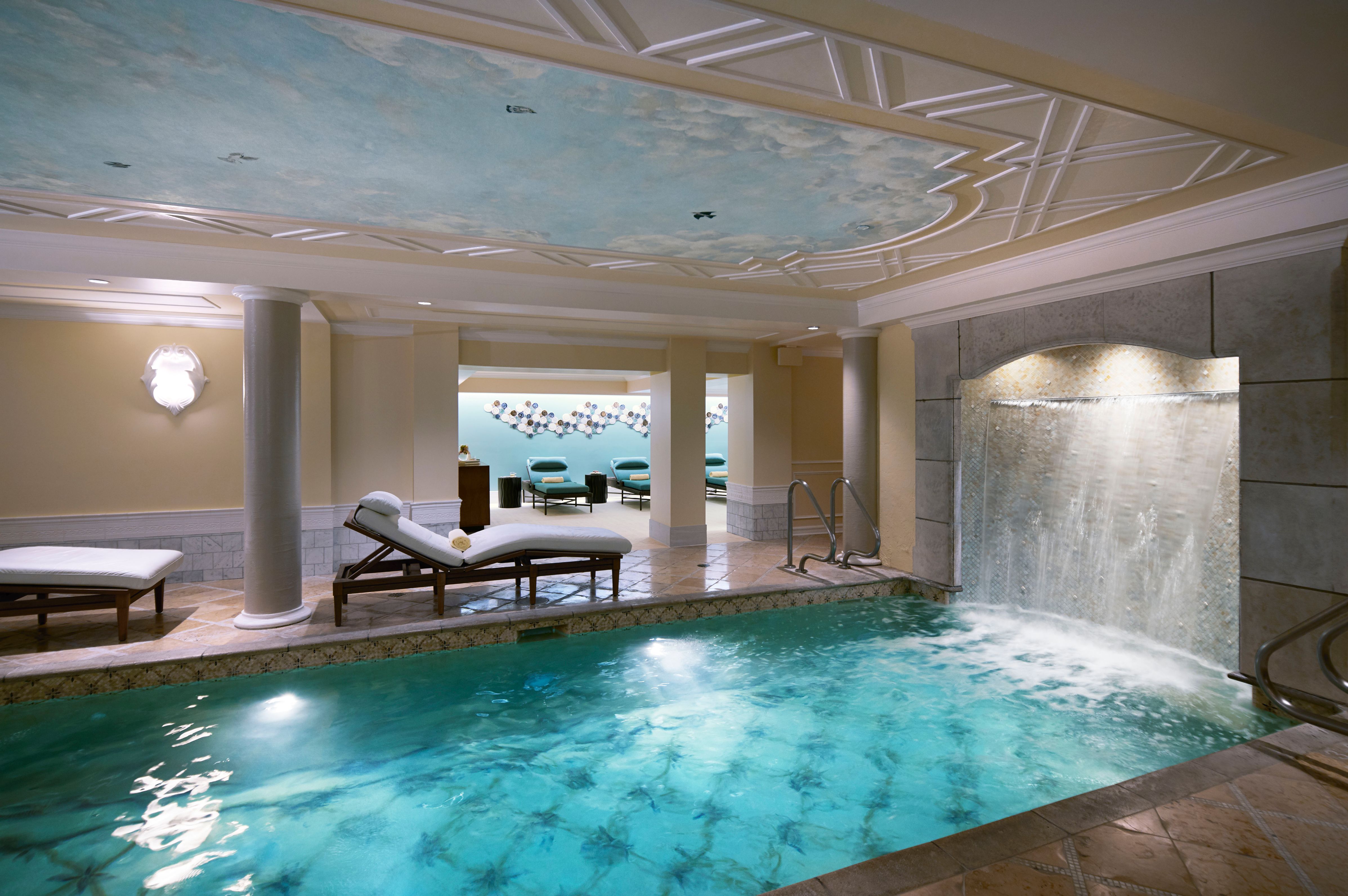 a indoor pool with a waterfall