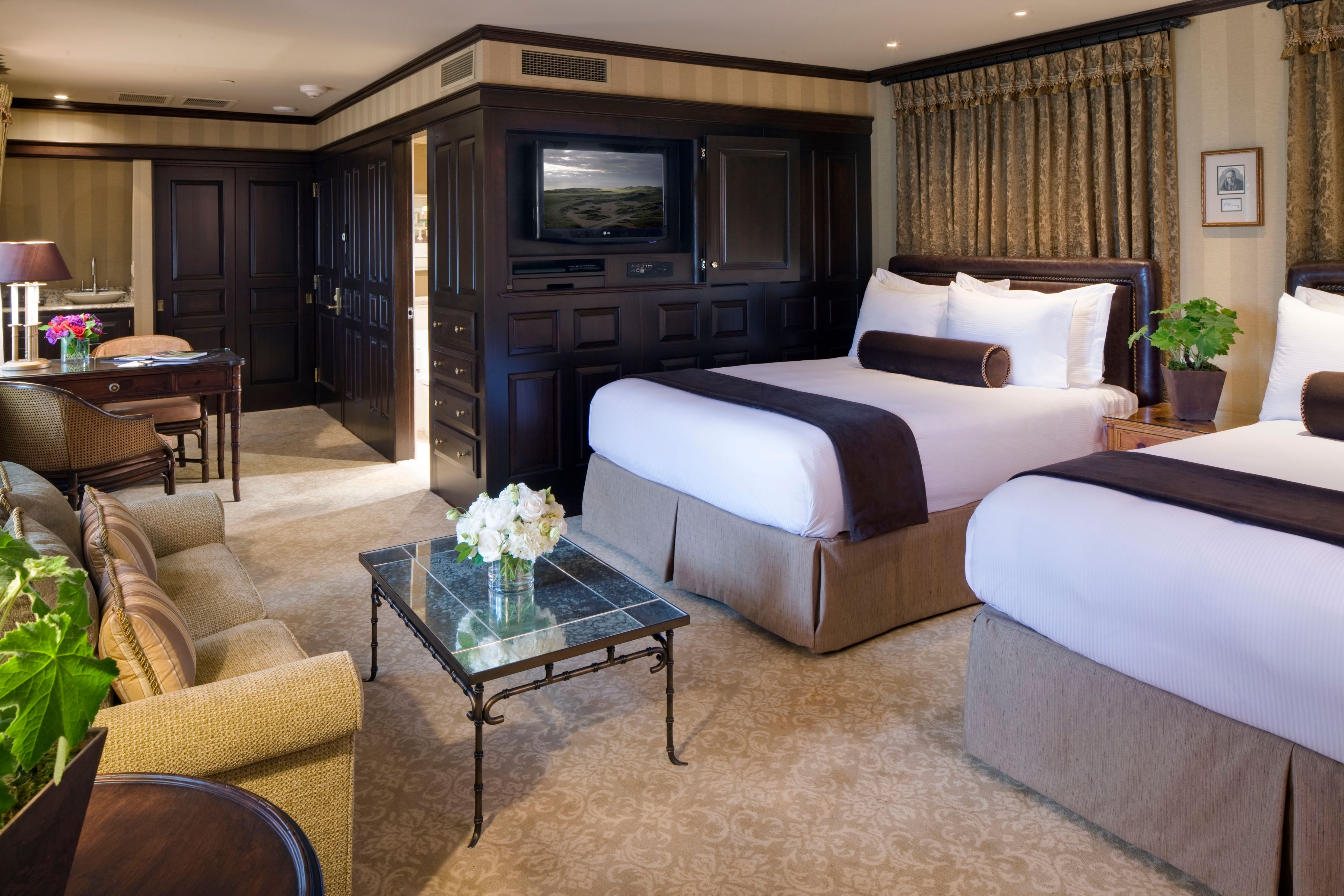 a hotel room with two beds and a television