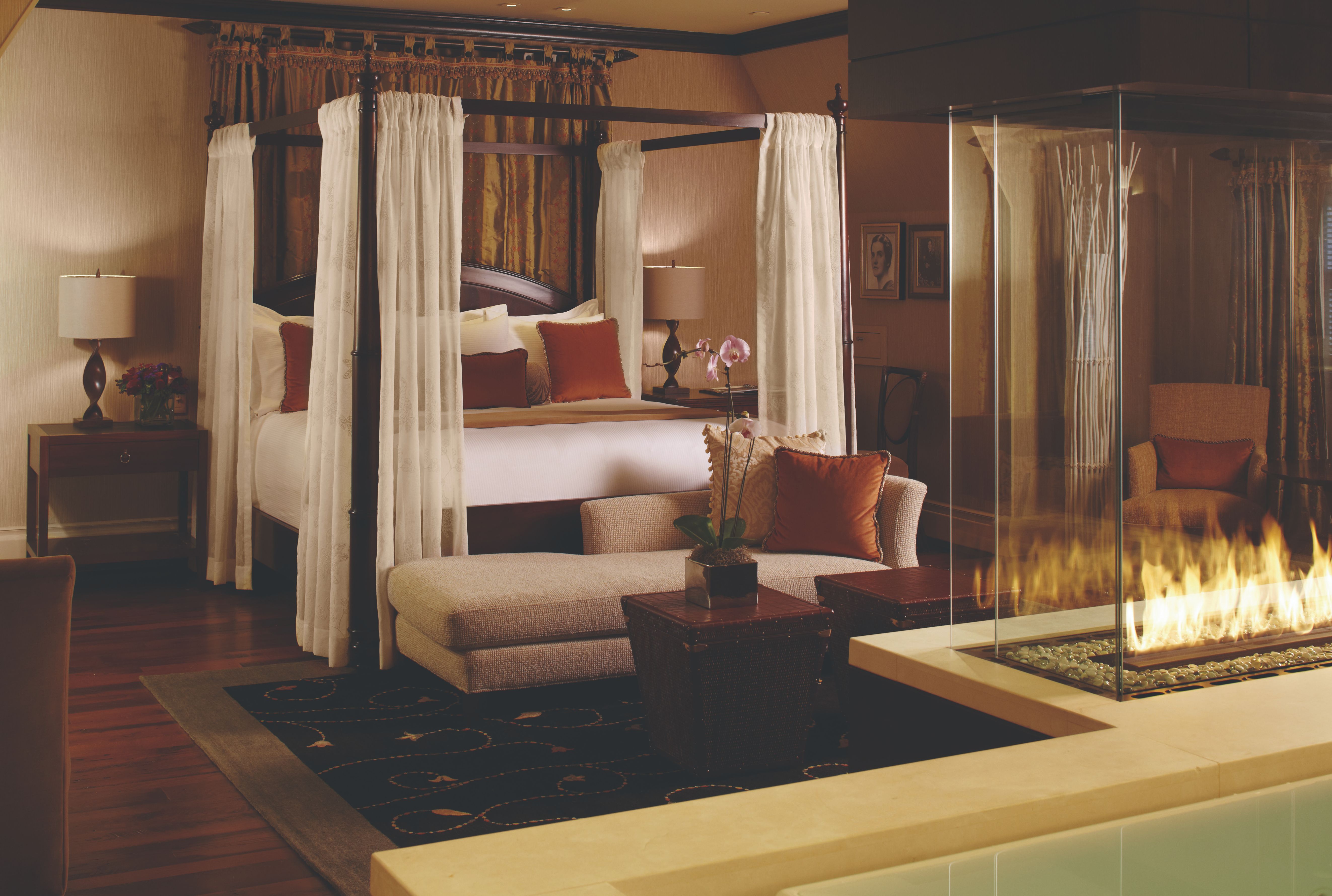 a room with a bed and a fireplace