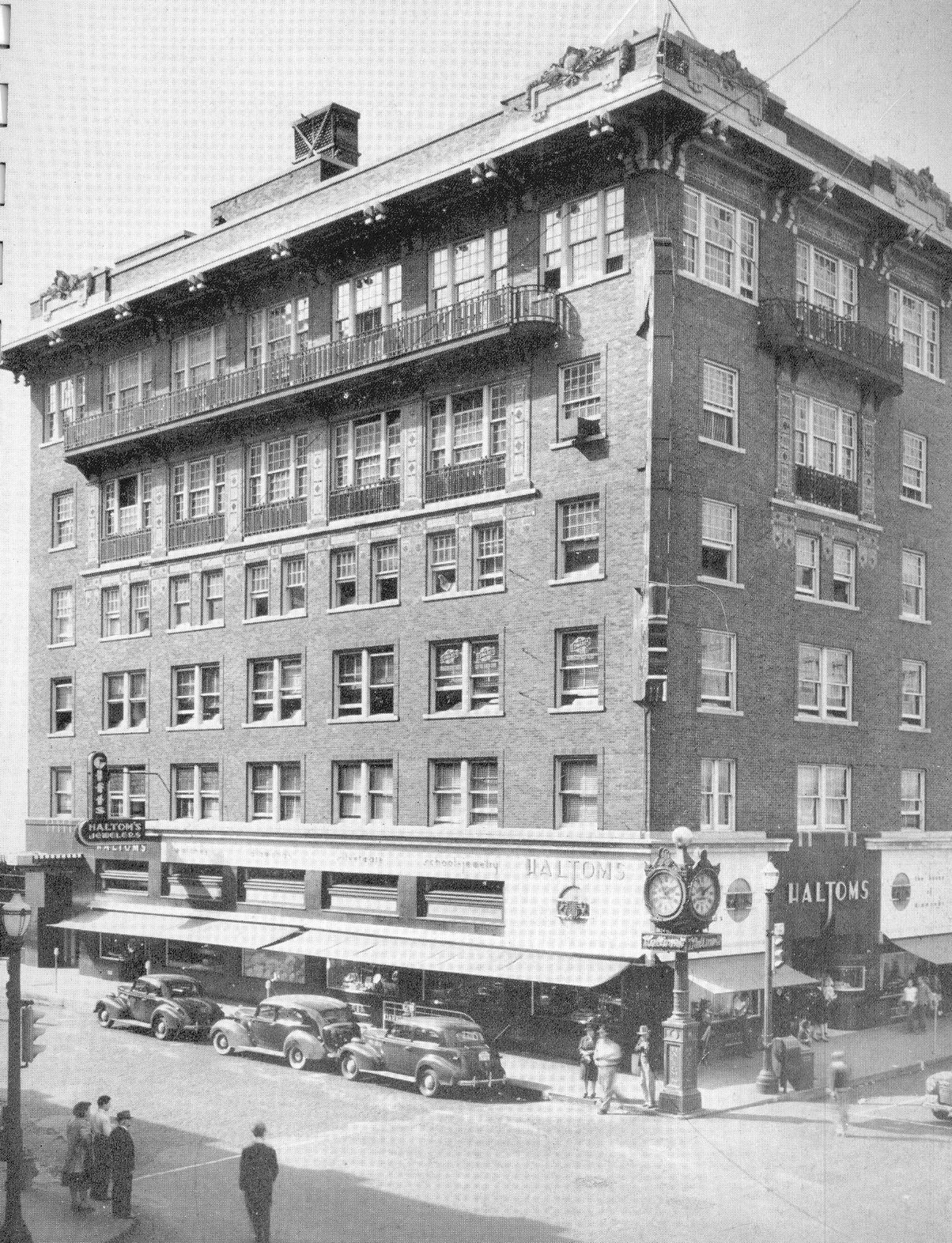 a building with cars parked on the corner