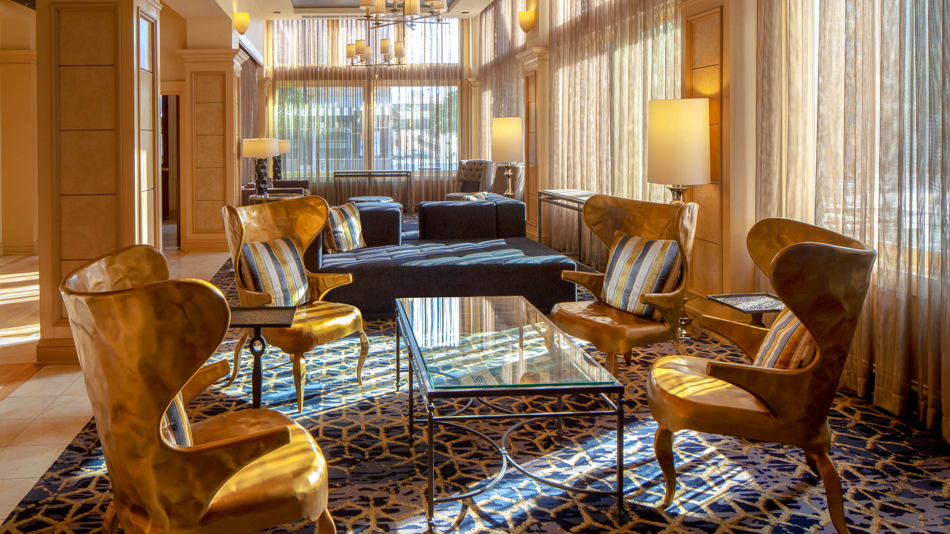 a room with a couch and chairs
