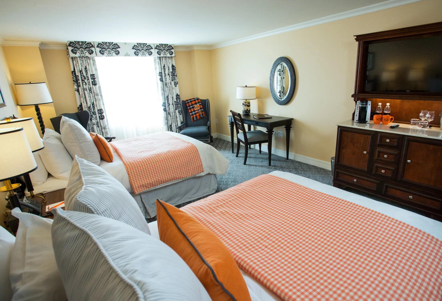 a room with two beds and a desk
