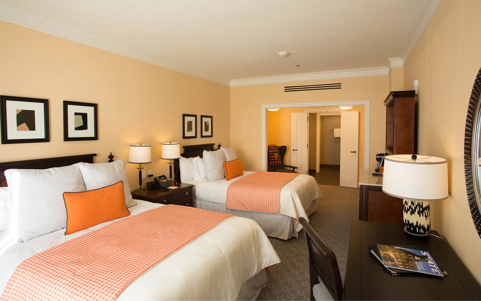 a room with two beds and a desk