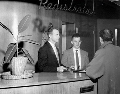 a group of men in suits at a reception desk