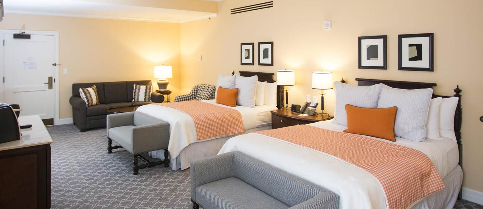 a room with two beds and a couch