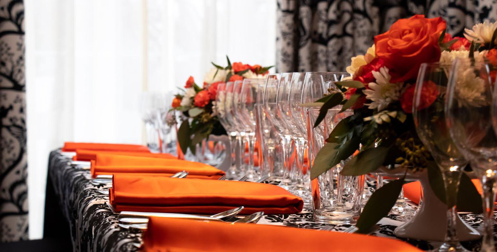 a table with glasses and flowers