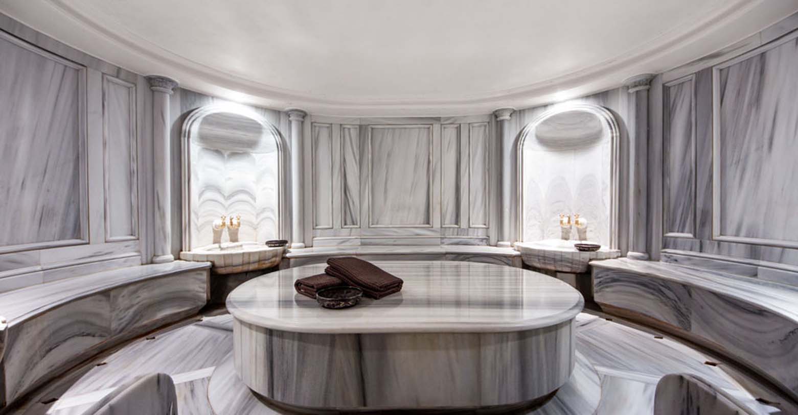 a large round table in a room with marble walls