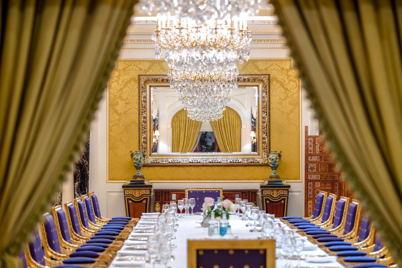 a large dining room with a chandelier and chairs