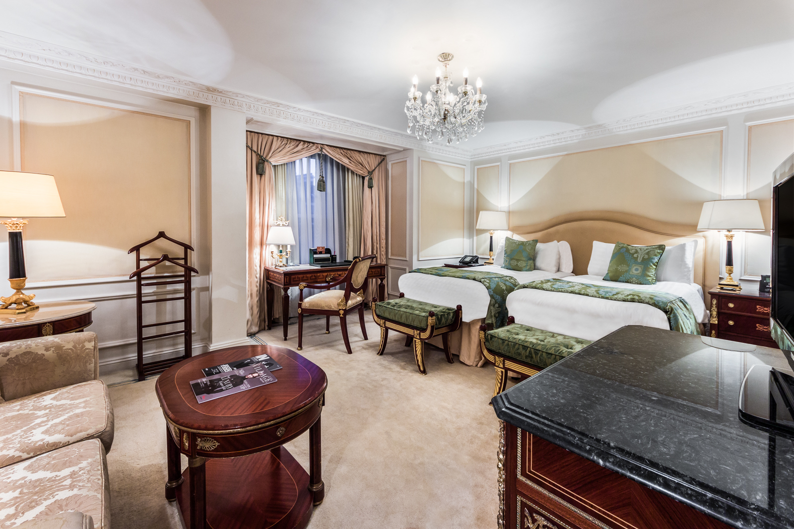 a room with two beds and a table