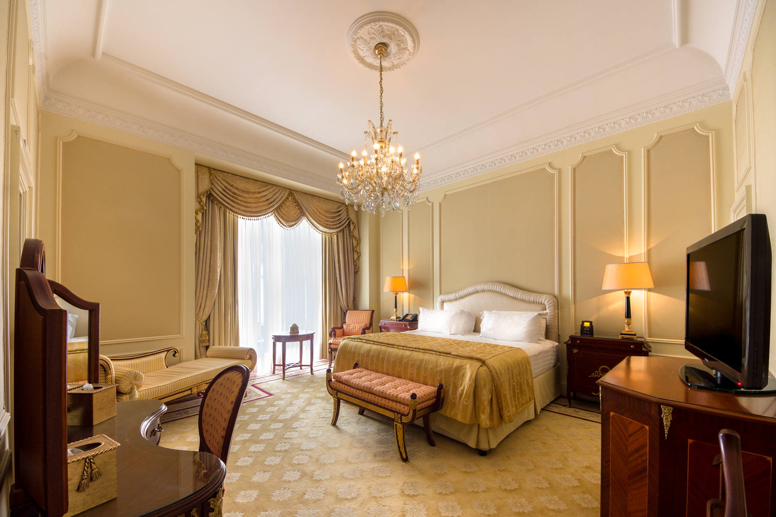 a bedroom with a chandelier and a bed