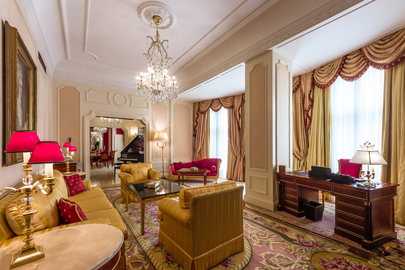 a room with a chandelier and couches