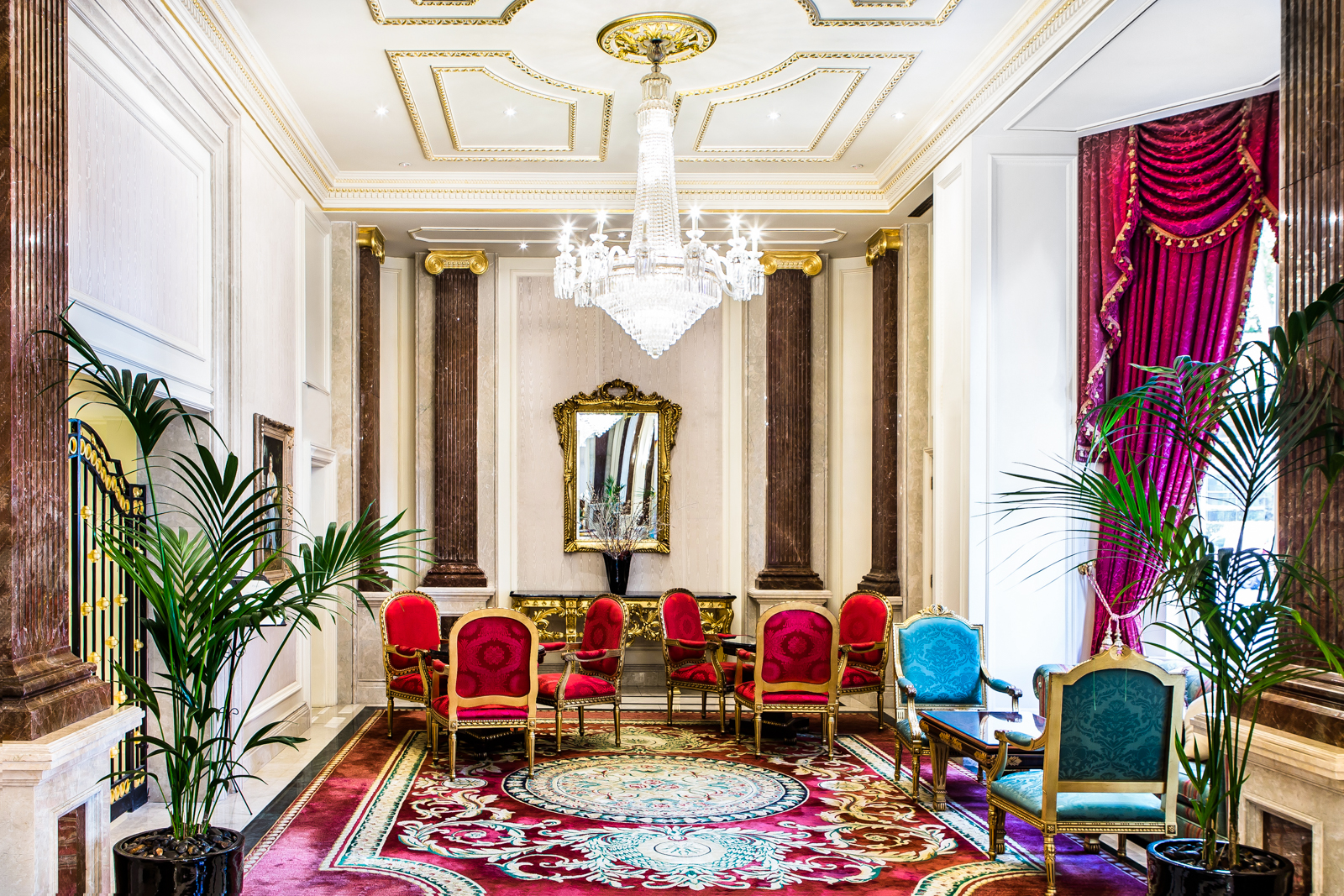 a room with chairs and a chandelier