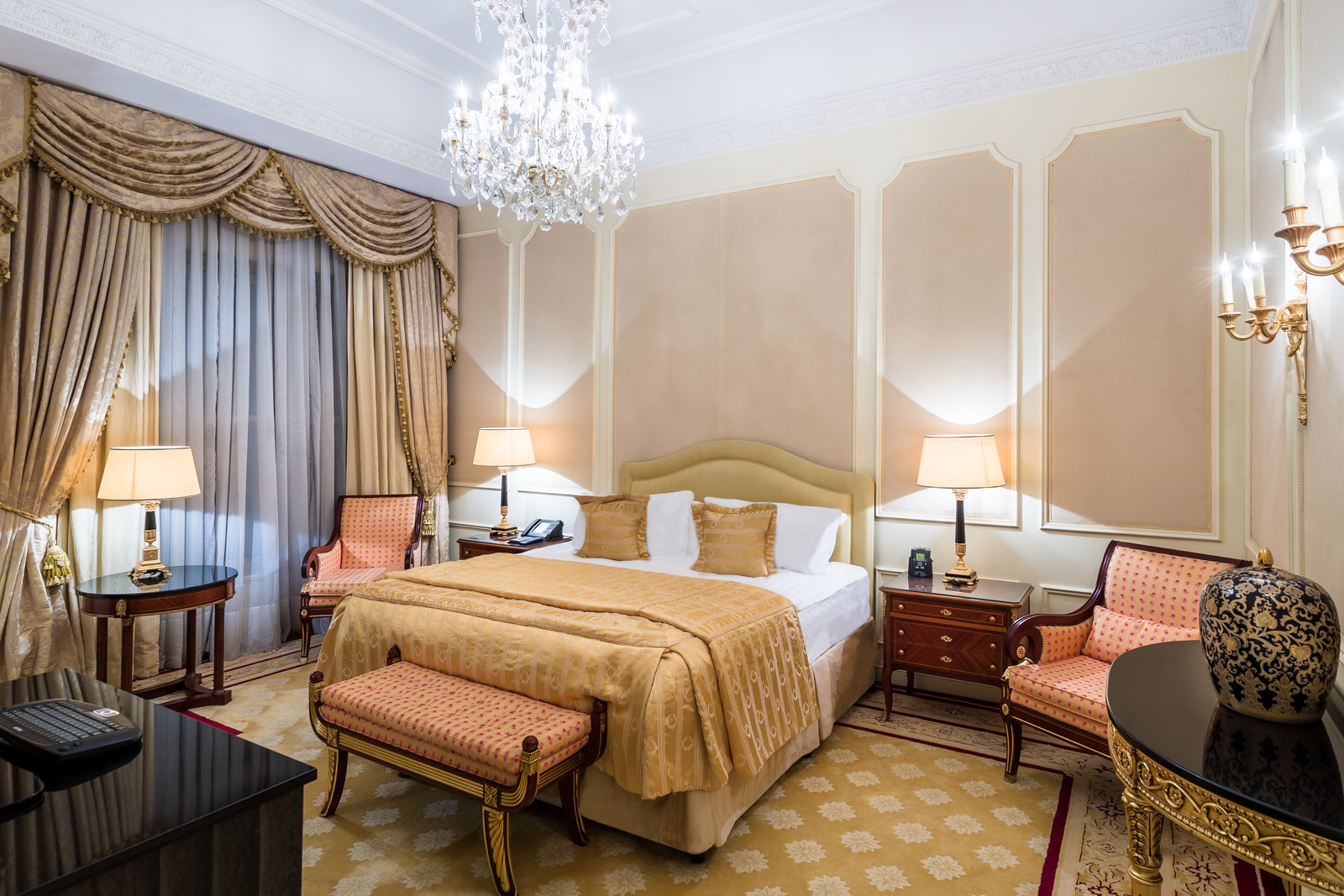 a bedroom with a bed and chairs