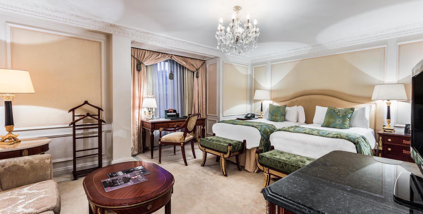 a room with two beds and a desk