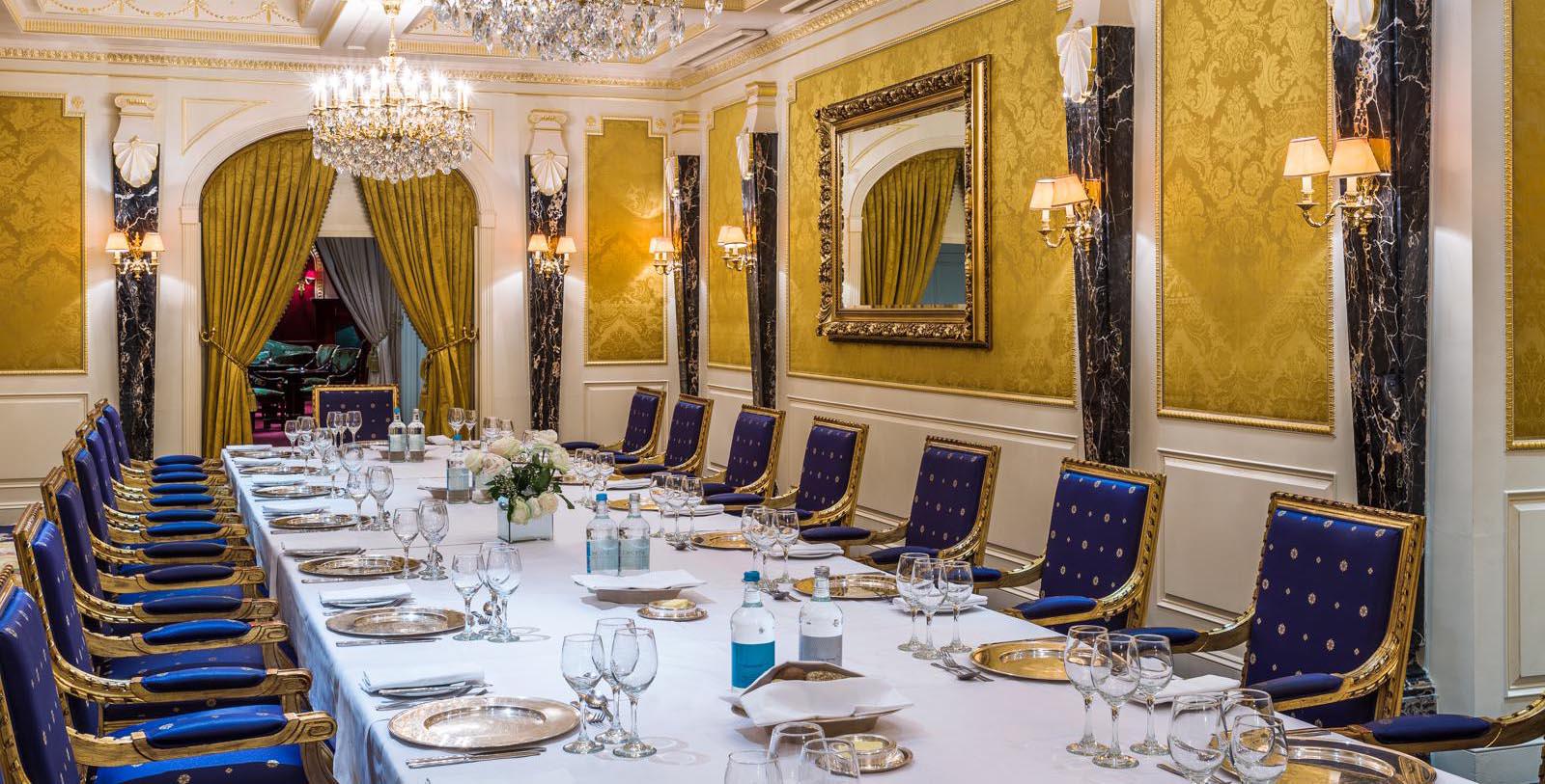 a long table with empty glasses and plates