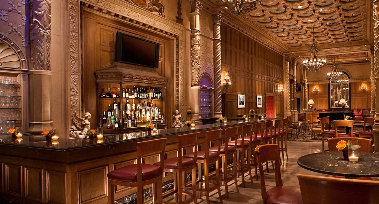 a bar with many chairs and a tv