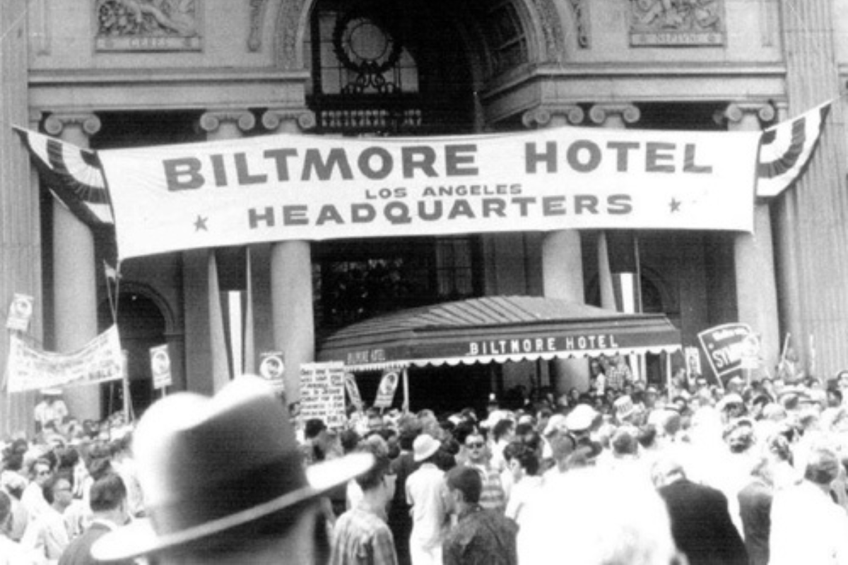 a group of people outside a hotel