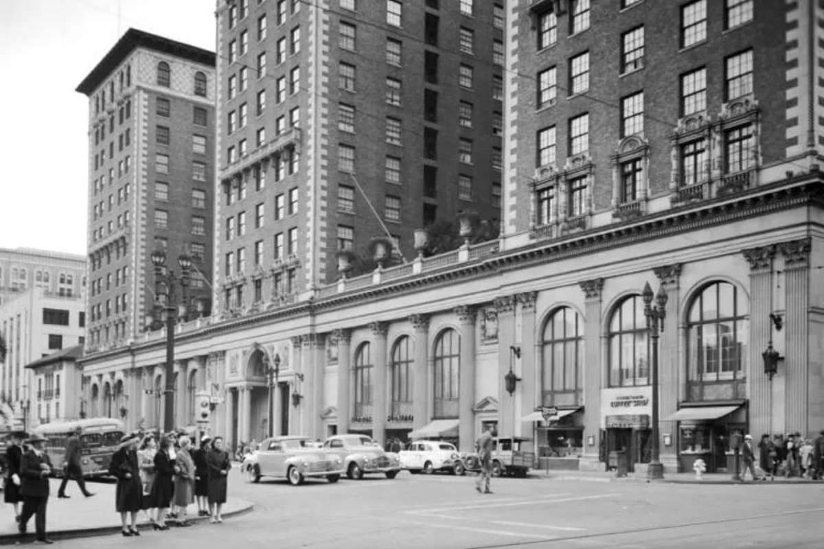 a group of people standing on a street corner