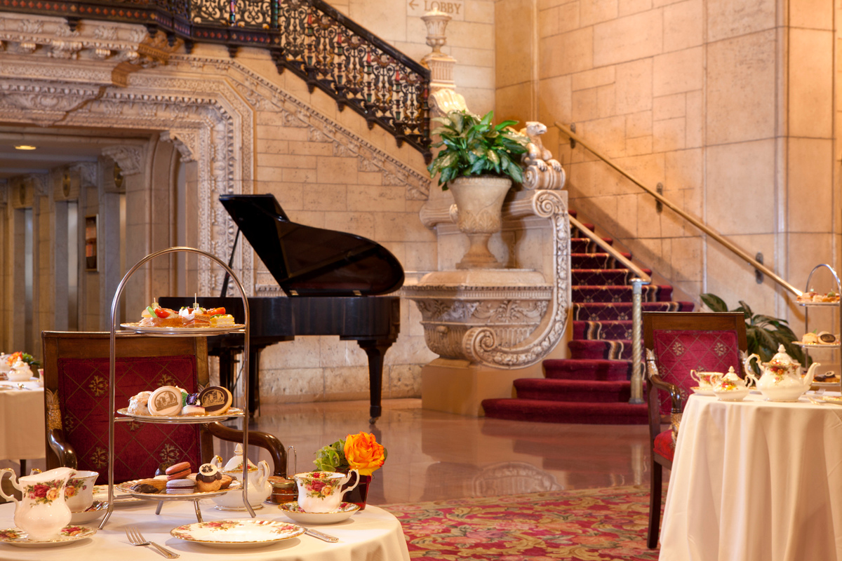 a room with a grand piano and a tea set