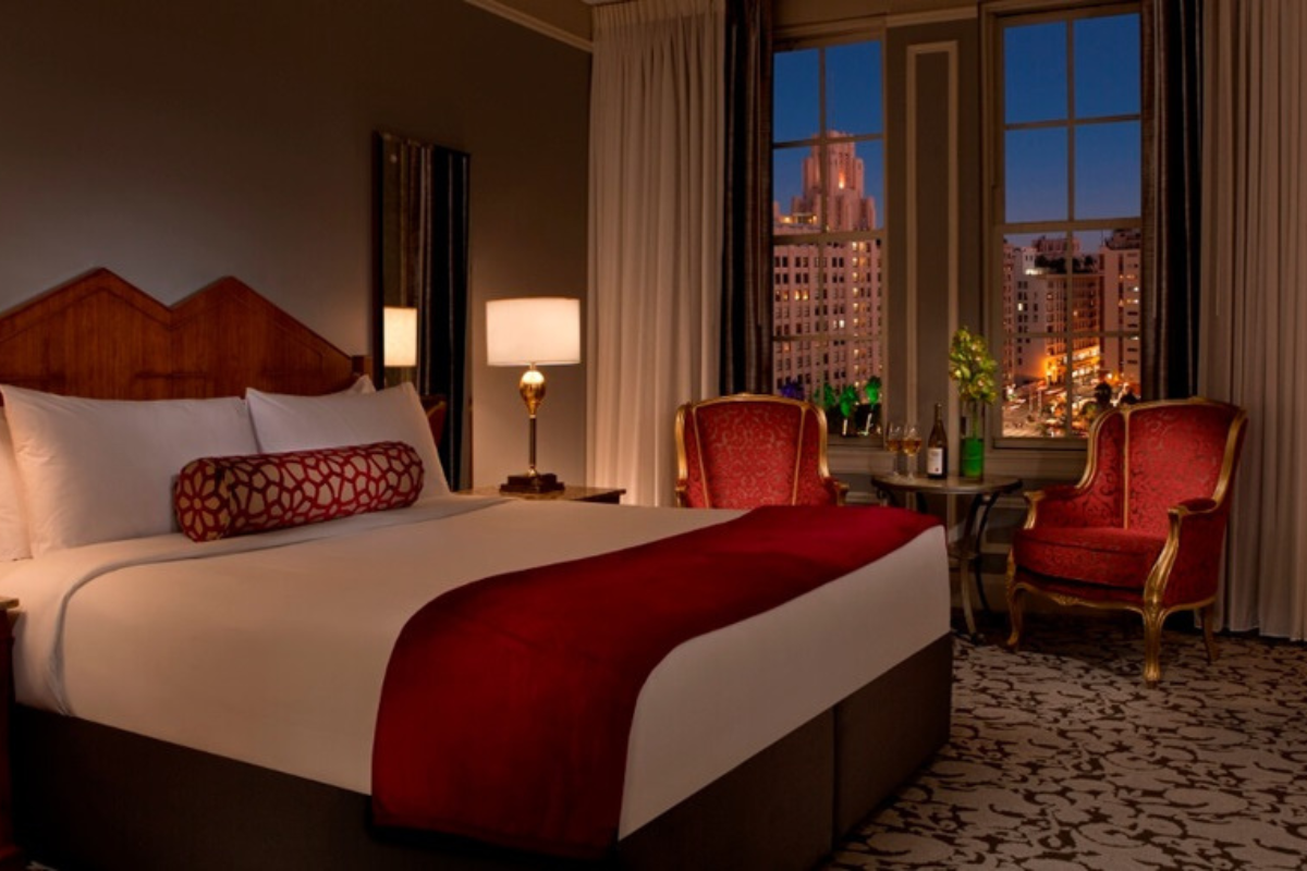 a hotel room with a bed and chairs