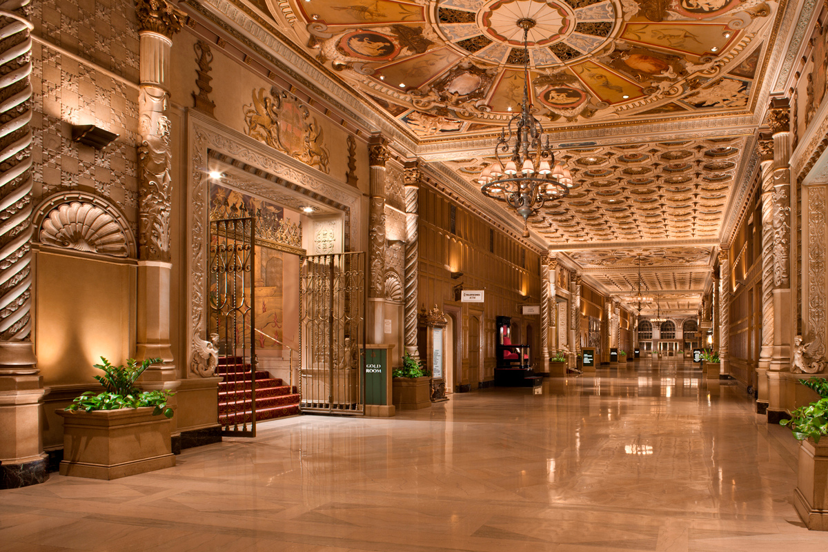 a large ornate hallway with art on the ceiling