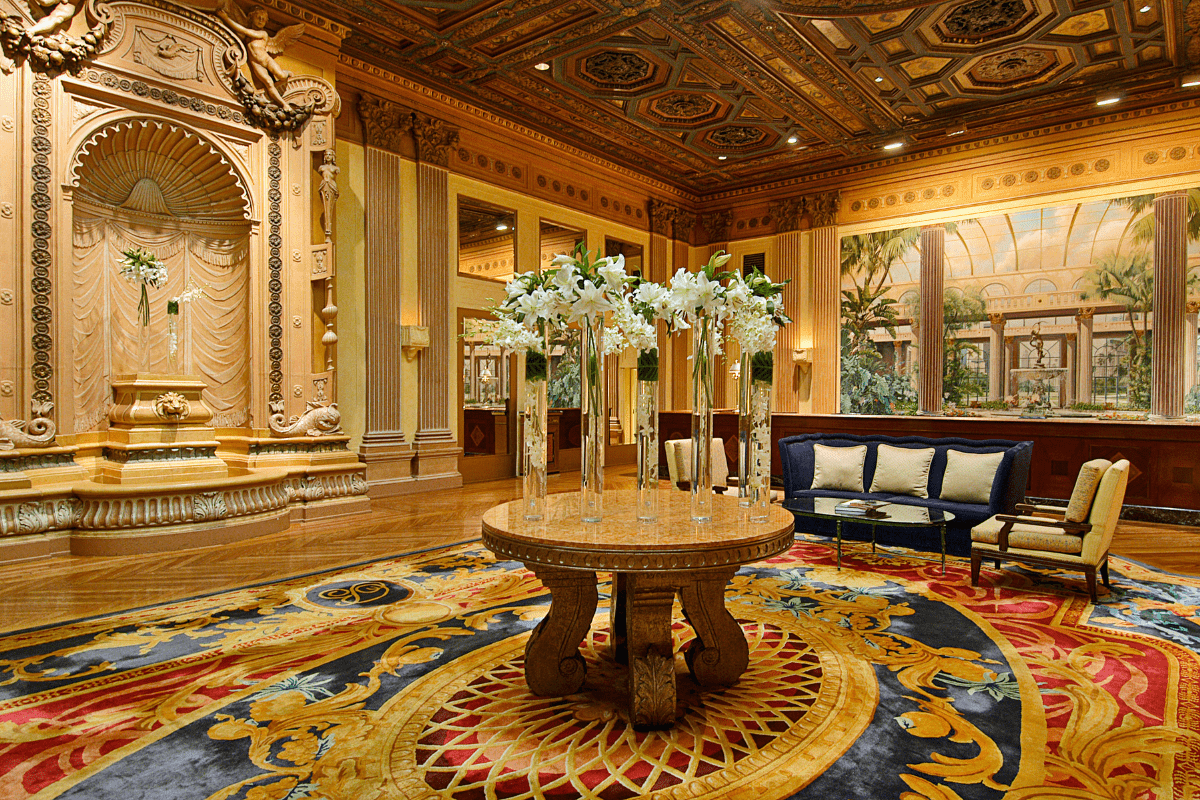 a room with a large round table with white flowers on it