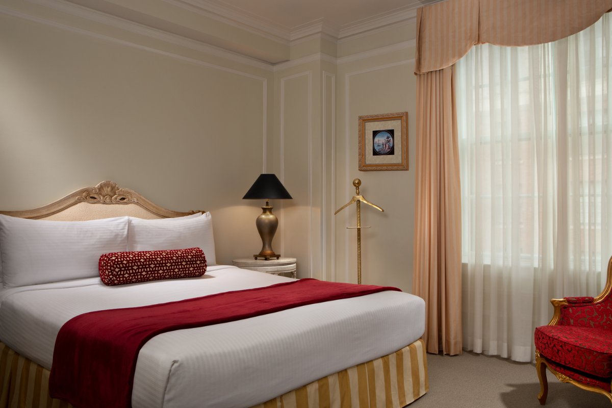 a bed with a lamp in a room