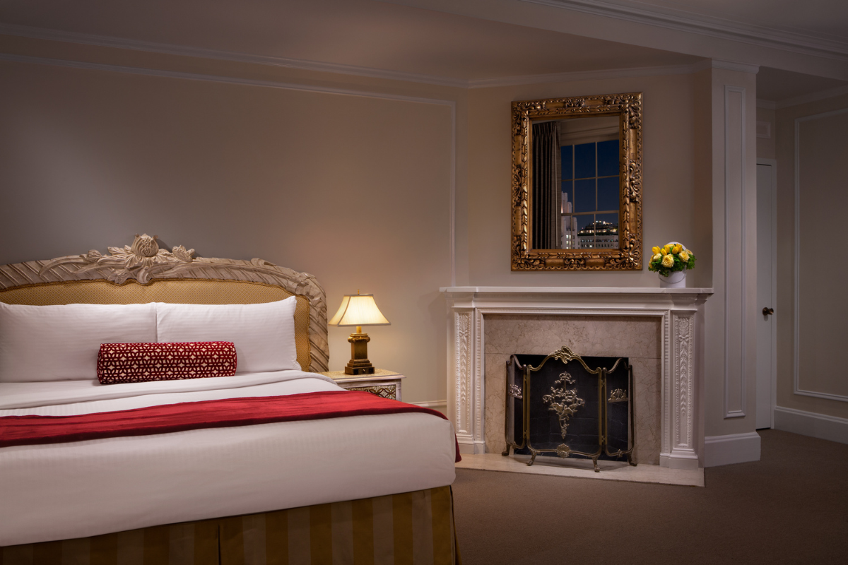 a room with a fireplace and a bed