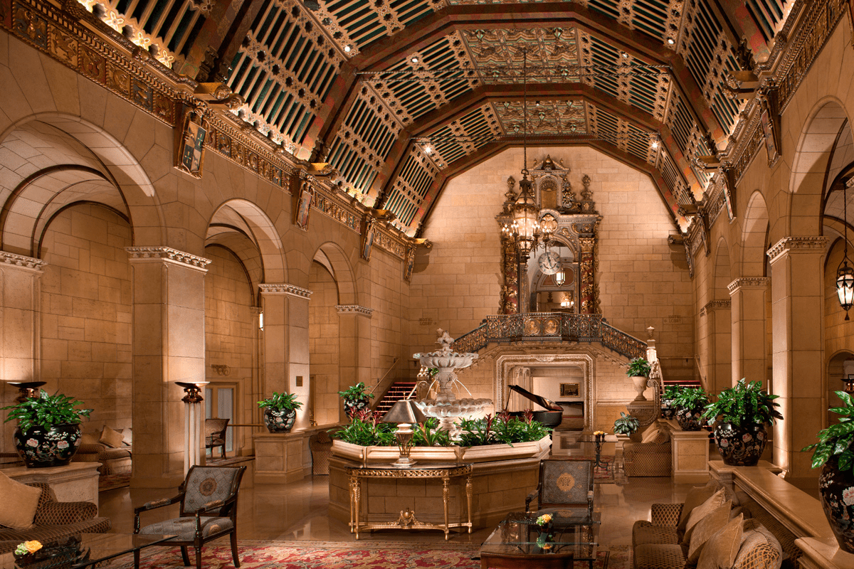 a room with a fountain and a staircase