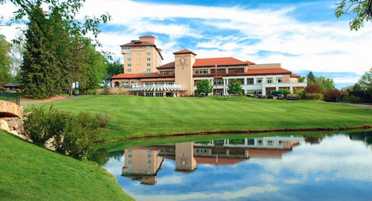 a large building with a pond in front of it