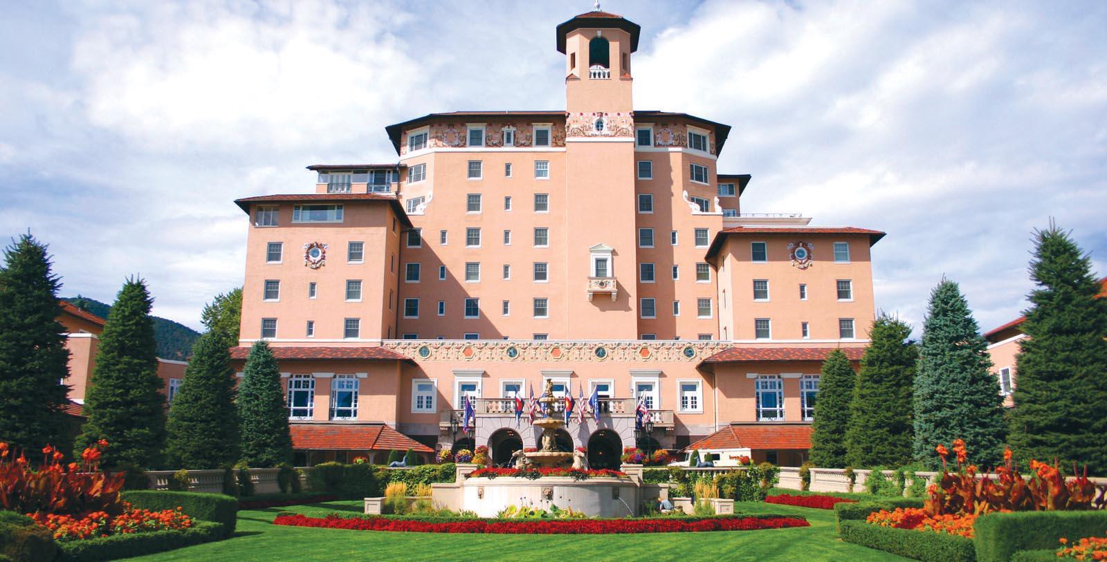 a large building with a fountain in front of it with The Broadmoor in the background